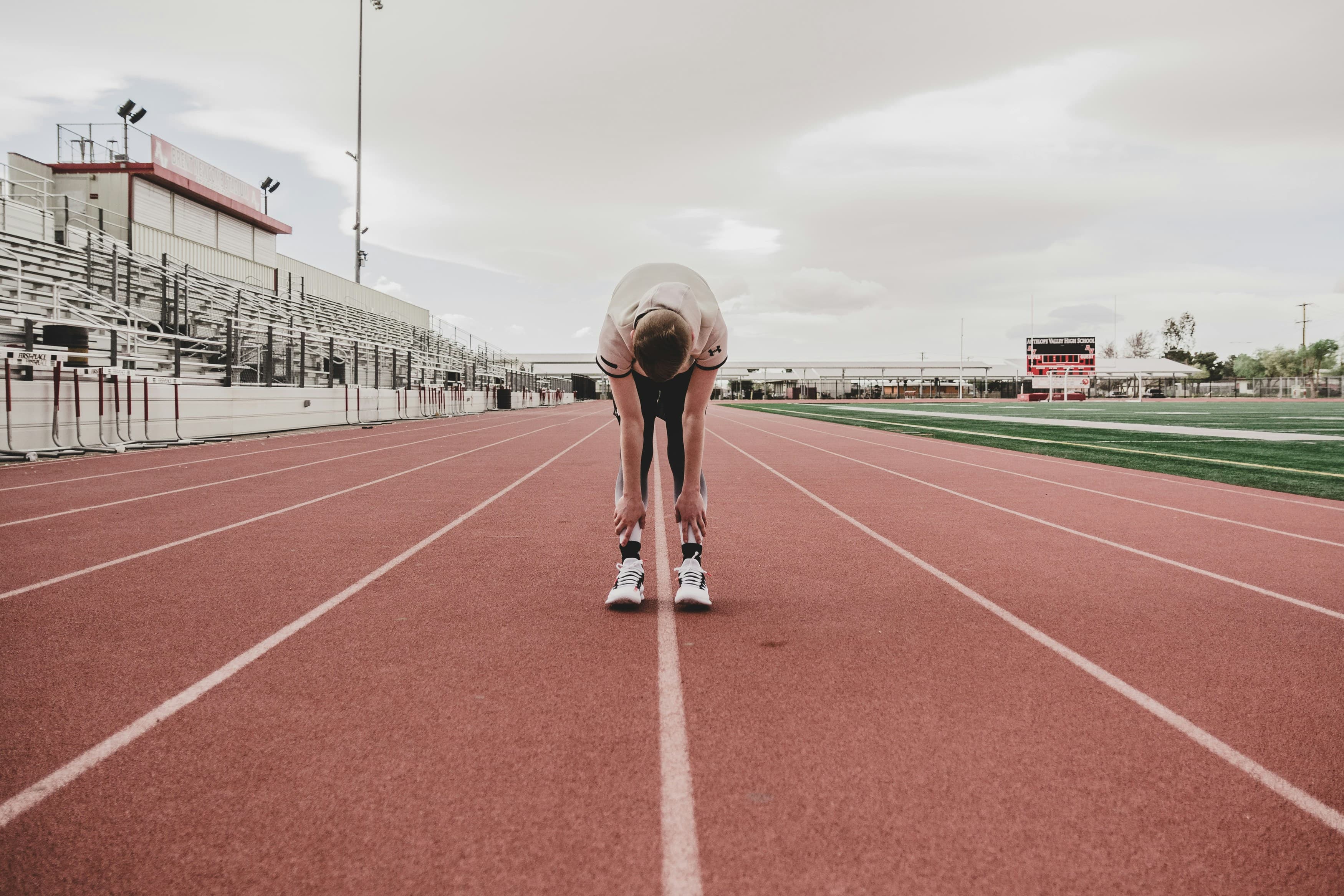 Athlete stretching on the track